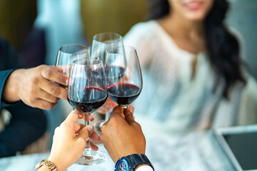 Multi-ethnic business people company teamwork employee enjoy celebration party having lunch and drinking wine after success mergers corporate business project agreement at skyscraper restaurant bar.