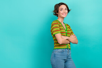 Photo of confident dreamy lady wear striped cardigan arms crossed looking back empty space isolated teal color background