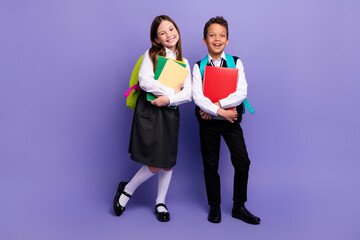 Photo of two school kids ready for first day buying supply for learning isolated bright color background