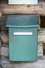 Mailbox with empty white label outside the wooden lean-to shelter