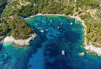 Aerial photo of boats moored at beautiful Velo Borce beach on Hvar island in Croatia