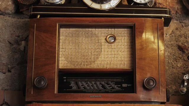Retro broadcast radio receiver on wooden table Listen music concept. Vintage instagram old style music player.