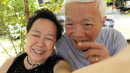 Asian senior elder couple taking selfie together fun retire trip together