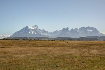 Aerial view of field surrounded by mountains