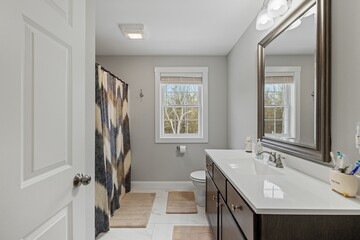 Modern bathroom with a large wall-mounted mirror and a contemporary sink.