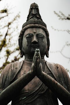 Stock photo depicts a bronze statue of the Buddha
