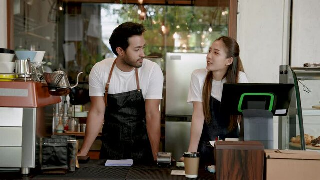 Portrait, Handsome young couple, beautiful Asian woman, two people are standing discussing opening this cafe business together, earn money from opening coffee shop that is very intended.