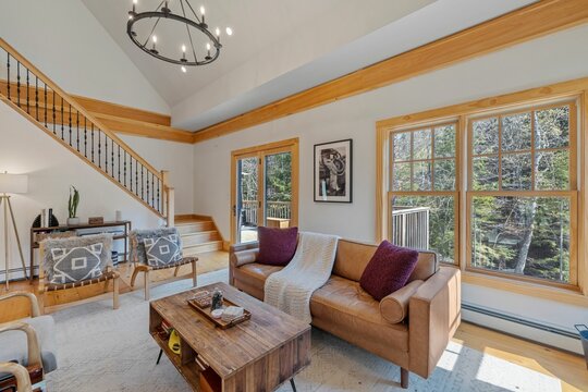 The cozy living room features two comfortable armchairs and a rustic coffee table