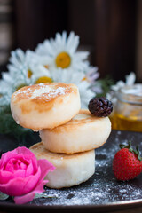 curd cheesecakes on a black plate. Grocery still life, cooking recipe