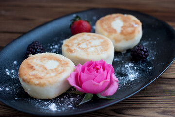curd cheesecakes on a black plate. Grocery still life, cooking recipe