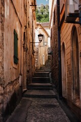 Fototapeta na wymiar Scenic pathway through a stone alley with stairs in Herceg Novi, Montenegro