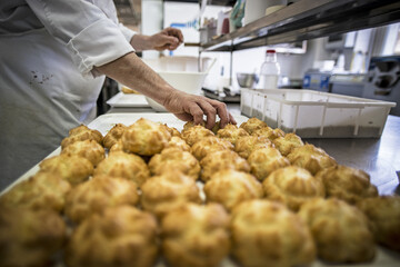 Production of delicious desserts and cakes with cream, and strawberries in a confectionery factory in Sicily, Italy