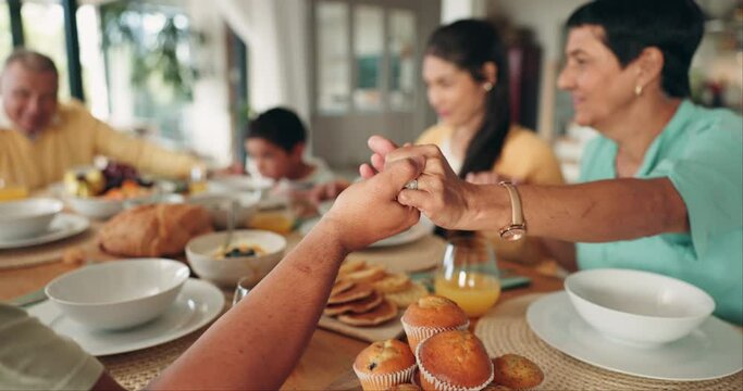 Holding hands, family and praying for lunch in home for worship, gratitude and spiritual. Prayer, food and parents, grandparents and children saying grace, blessing and thanks before eating brunch