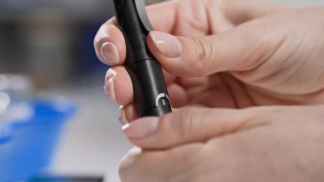diabetes treatment, female hand holding glucometer to measure blood sugar, close-up