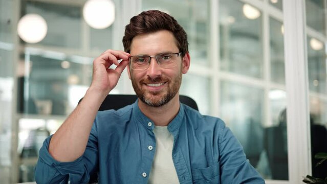 Close up face of smiling bearded man businessman putting off glasses, looking at camera with healthy white smile. Portrait of successful bank worker, manager, employee posing for busines portrait.