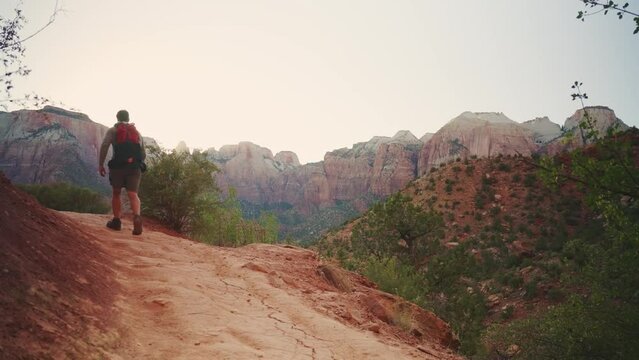 Hiker person walking at the Watchman Trail in the Zion National Park