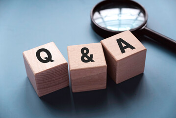 Q&A or questions and answers concept. Wooden cube written with letter Q and A.
