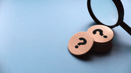 Q&A or questions and answers concept. Wooden circle written with question mark symbol.