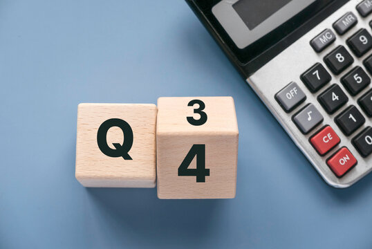 Quarterly report concept.Company financial report.Business charts. Wooden cube represent quarter third and fourth.