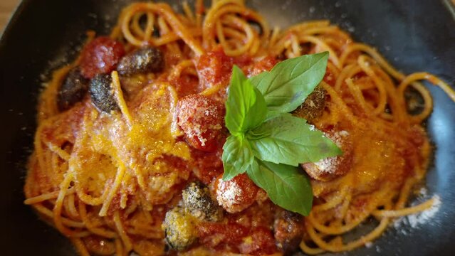 Italian spaghetti with tomatoe and basilic in a restaurant close up