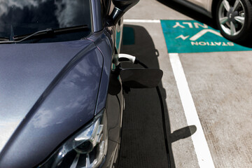 Electric car charging station. Hybrid car Electric charger station in the Car Park. Electric car charging on parking and charging station. Electric socket. Transportation EV.
