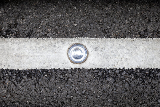 Round glass reflector on the road .  Road reflector for night ride safety. Traffic transport construction maker street safety road by use reflective glass road stud. Glass road stud