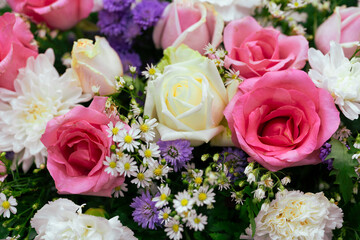 Creative layout made of colorful flowers and leaves for decoration at wedding.Roses in a mixed flower bouquet on vintage style.Floral background.