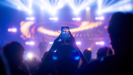 People holding smart phone and recording and photographing in concert , silhouette of hands with mobile , event background concept