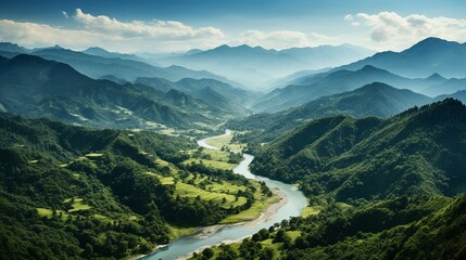 An aerial picture of a river in a lush, tropical forest with mountains in the distance..
