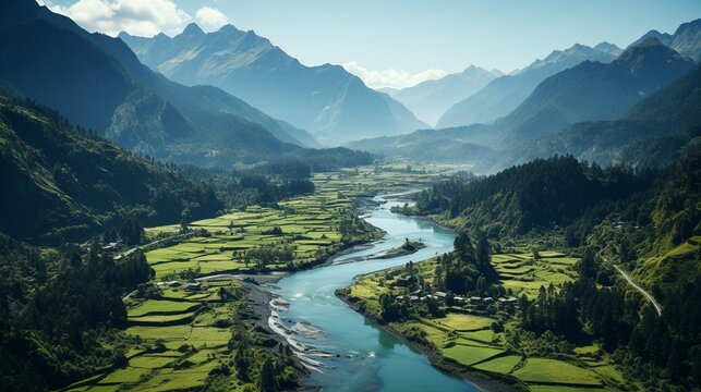 An aerial picture of a river in a lush, tropical forest with mountains in the distance..