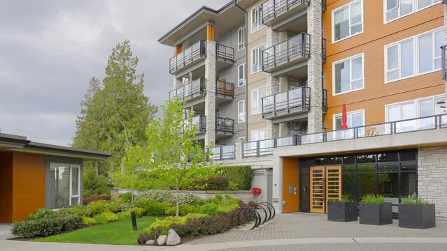 Establishing shot of modern apartment building with beautiful spring blossom landscape in Vancouver, Canada, North America. Day time on April 2023. ProRes 422 HQ.
