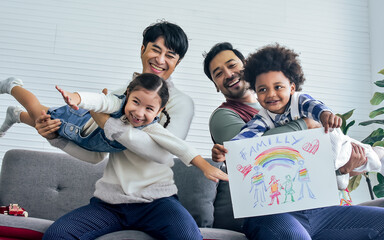 Male gay taking care adopted children who are happy diverse little Caucasian girl and African boy,...