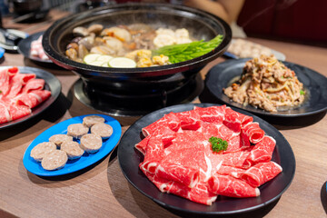 Hotpot with fresh slice of meat and food in restaurant