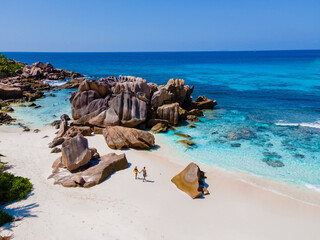 Anse Cocos La Digue Seychelles, couple of men and women on a tropical beach during a luxury...