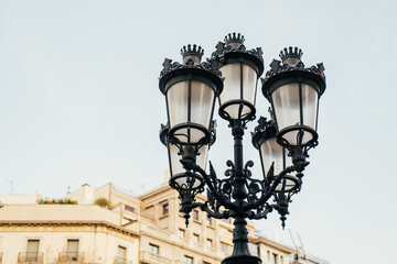 Close up shot of s beautiful street black lamp in old vintage style on day time.