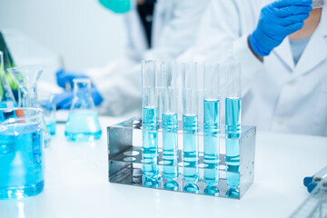Glassware, beaker or test tube with blue substance or liquid. Concept of laboratory background. Scientific analysis tools background. Chemistry and experiment glassware.