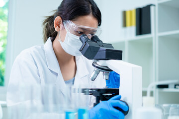 Medical Research Laboratory. Female Scientist Using Microscope to analyze substance or liquid, virus. Professionals Working in Advanced Scientific Lab doing Medicine, Vaccine, Biotechnology test