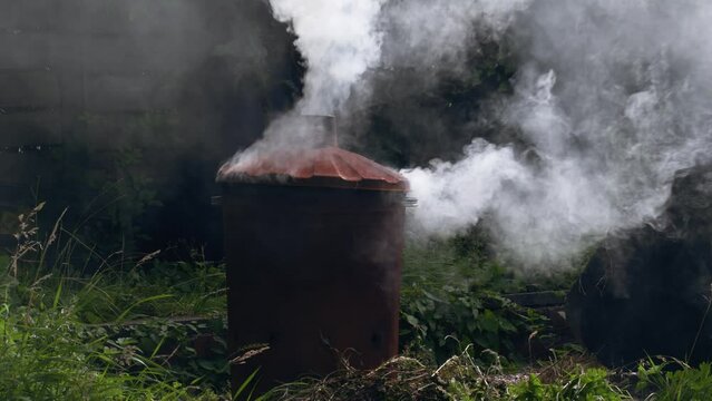 Garden and house garbage burning in a bin incinerator