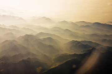 Flying over the misty mountains in the morning