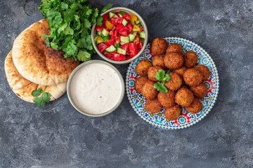 Traditional homemade chickpea Falafel balls with vegetables salad , tahini sauce,chips and pita...