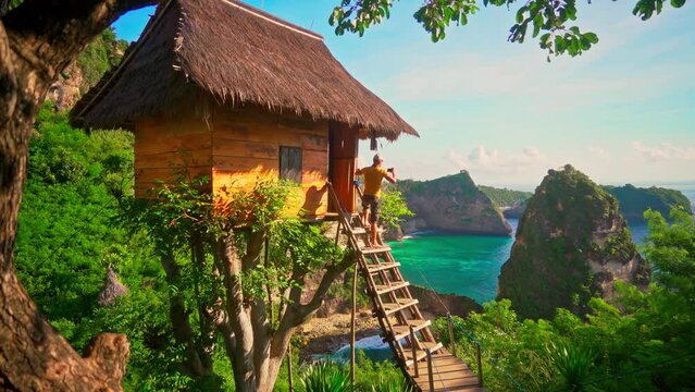 Travel people standing by scenery hut enjoy nature landscape with tropical beach and scenery mountain rocks in ocean on nature background 4K