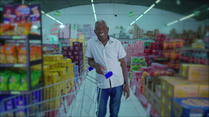 Smiling African American Elderly Shopper with Cart in Supermarket Aisle
