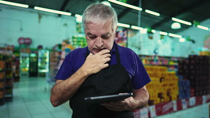 Stressed business owner of supermarket chain feeling pressure facing difficulties in grocery store operations. Portrait of a frustrated manager with unshaven beard and gray hair