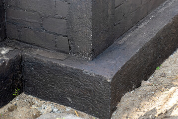 Footings made of concrete blocks painted with black dispersion asphalt-rubber mass, reinforced...