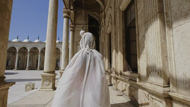 Woman is walking towards the Great Mosque of Muhammad Ali Pasha.