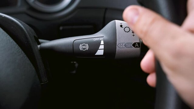 The truck driver switches the retard control lever. Close-up.