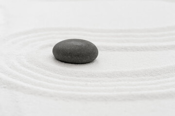 Fototapeta na wymiar Zen Garden with Grey Stone on White Sand Line Texture Background, Top View Black Rock Sea Stone on Sand Wave Parallel Lines Pattern in Japanese stye, Simplicity Day, Meditation,Zen like concept.