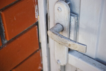 A closeup shot of a close metal gate door with a doorknob