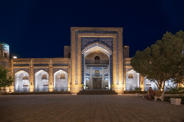 Obraz premium Matniyaz Divanbegi Madrasah facade illuminated at night in old city Ichan Kala, Khiva, Uzbekistan