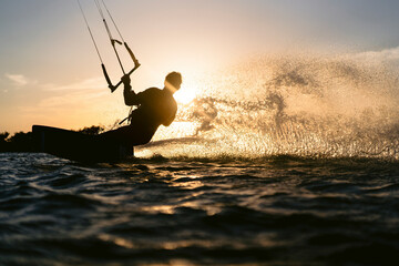 Epic kiteboarding moment while athlete has sunset session in Red Sea.